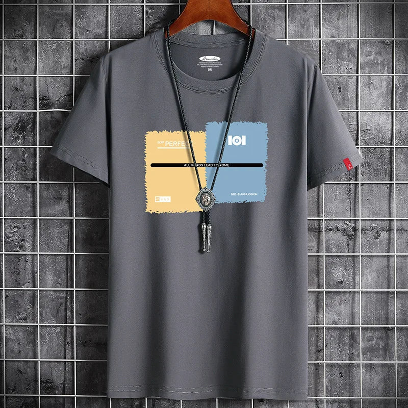 Gray t-shirt with colorful graphic design on a hanger against a tiled wall background