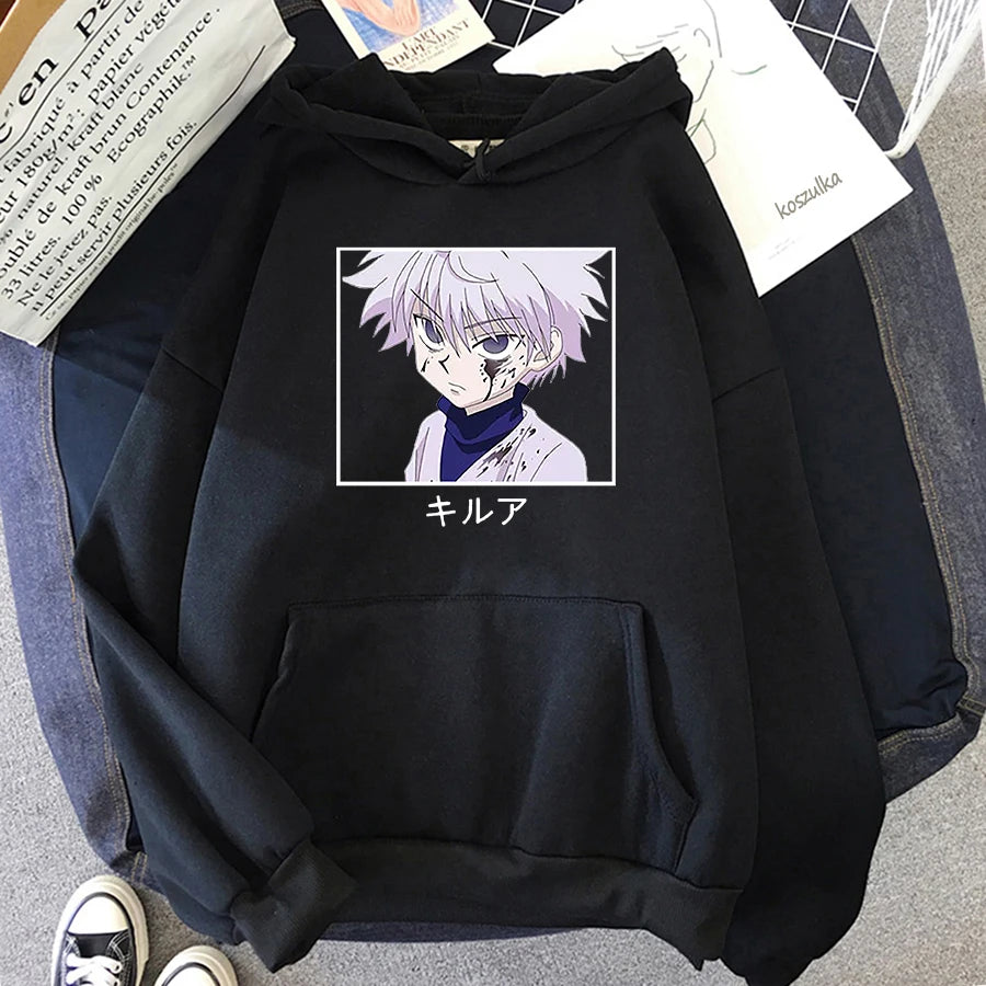 Black hoodie with anime character graphic on a gray surface