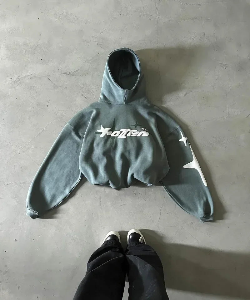 Gray hoodie with a brand logo on a concrete floor