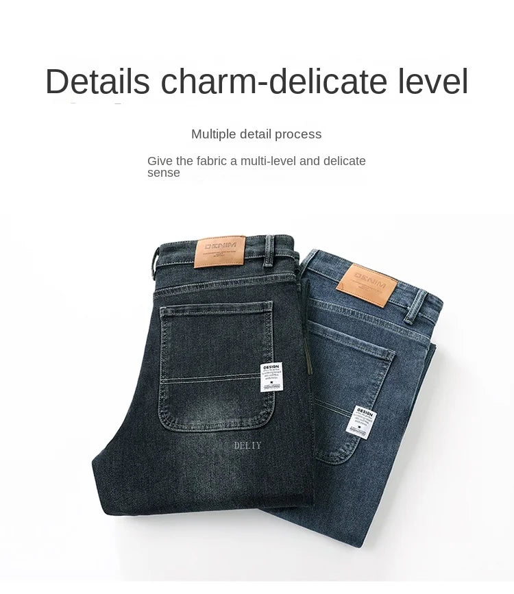 Pair of dark blue jeans with leather patches on a white background