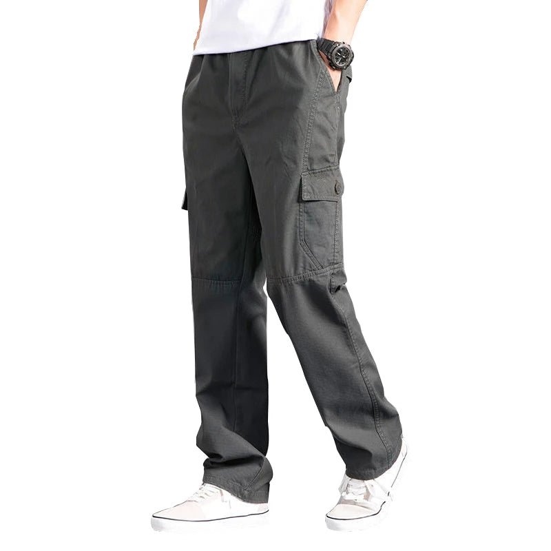 Person wearing gray cargo pants on a white background