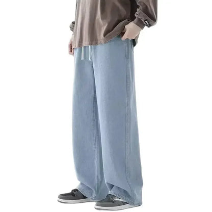 Person wearing light blue pants and a brown shirt on a white background