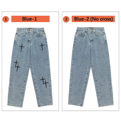 Two pairs of blue jeans with black cross designs on a white background