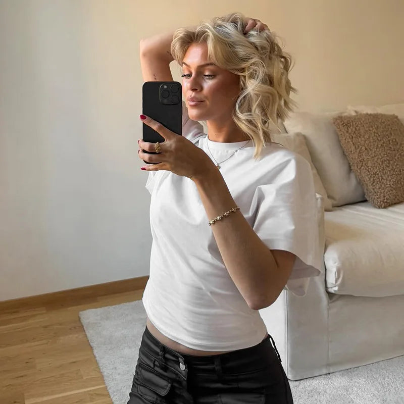 Woman taking a mirror selfie in a living room