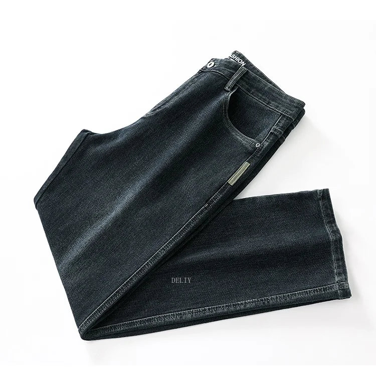 Folded black jeans on a white background