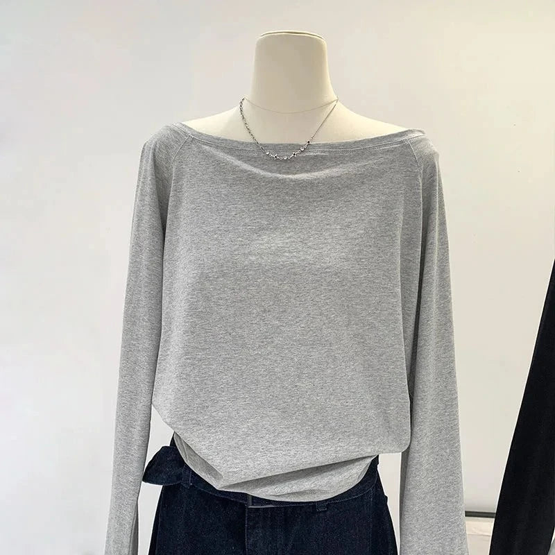 Gray long-sleeve top on a mannequin against a white background