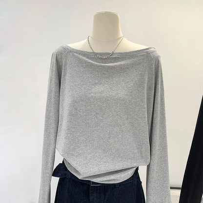 Gray long-sleeve top on a mannequin against a white background