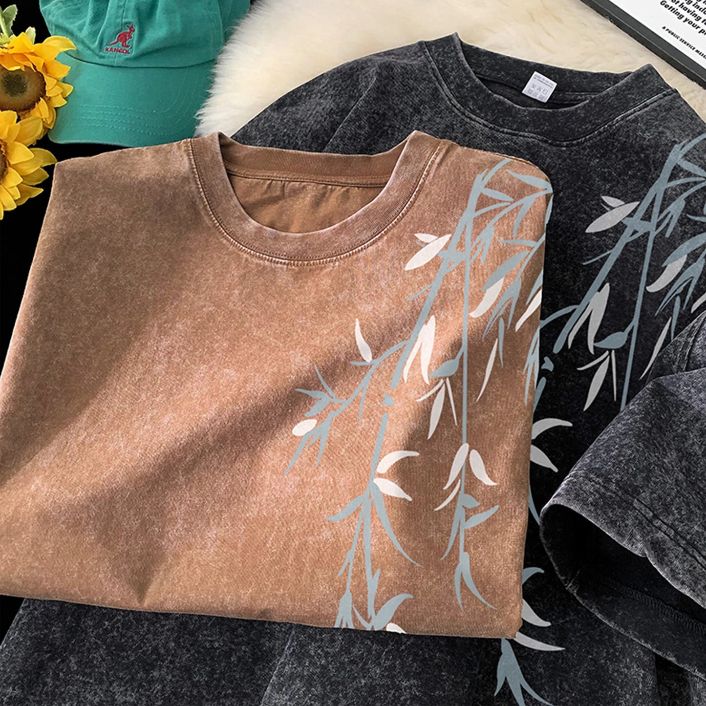 Folded brown shirt with leaf pattern on a black shirt background