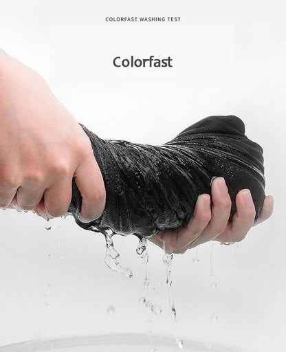 Person washing a black garment under running water with 'Colorfast' text above.