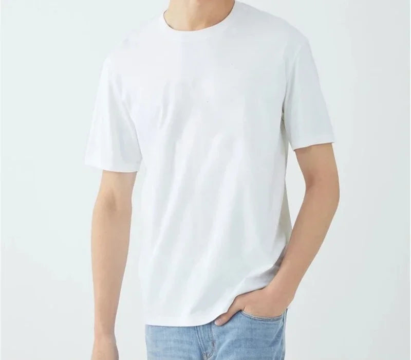 Person wearing a plain white t-shirt and light blue jeans on a light gray background