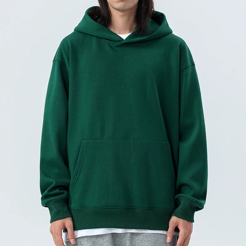 Person wearing a green hoodie on a white background