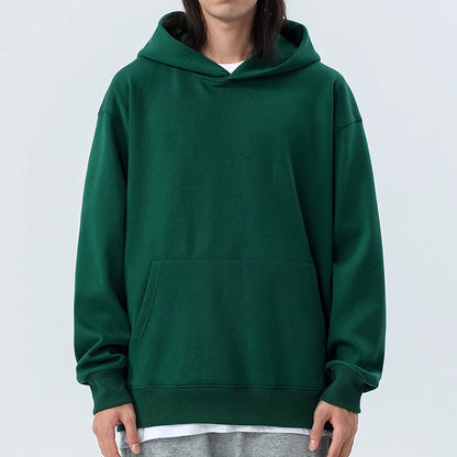 Person wearing a green hoodie on a white background