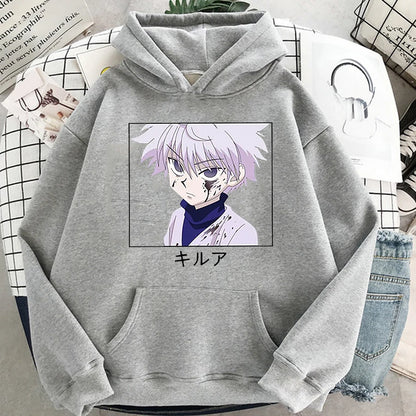 Gray hoodie with anime character print on a surface with books and jeans.