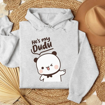 Gray hoodie with cartoon design and text on a woven surface