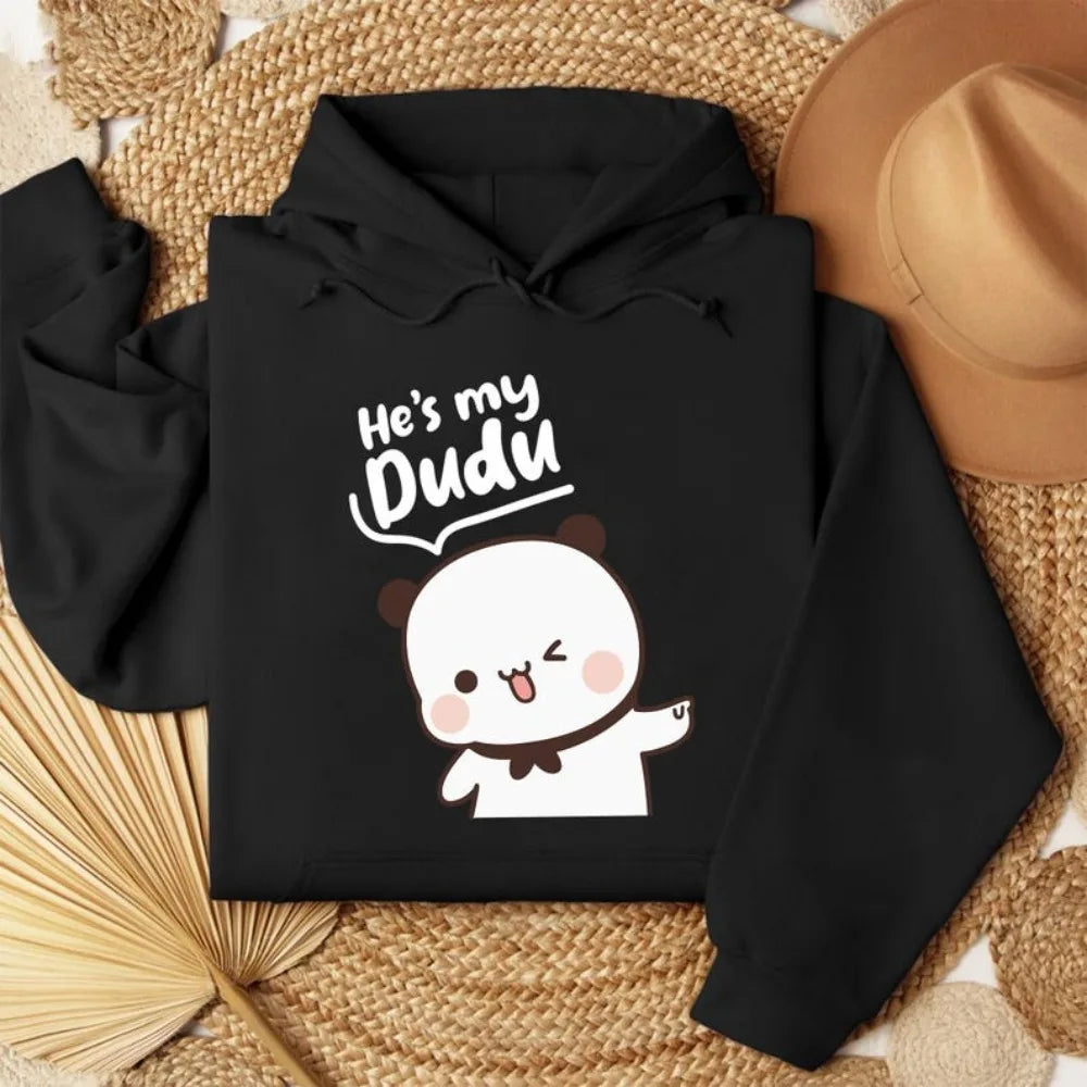 Black hoodie with cartoon character and text 'He's my Dudu' on a woven surface.