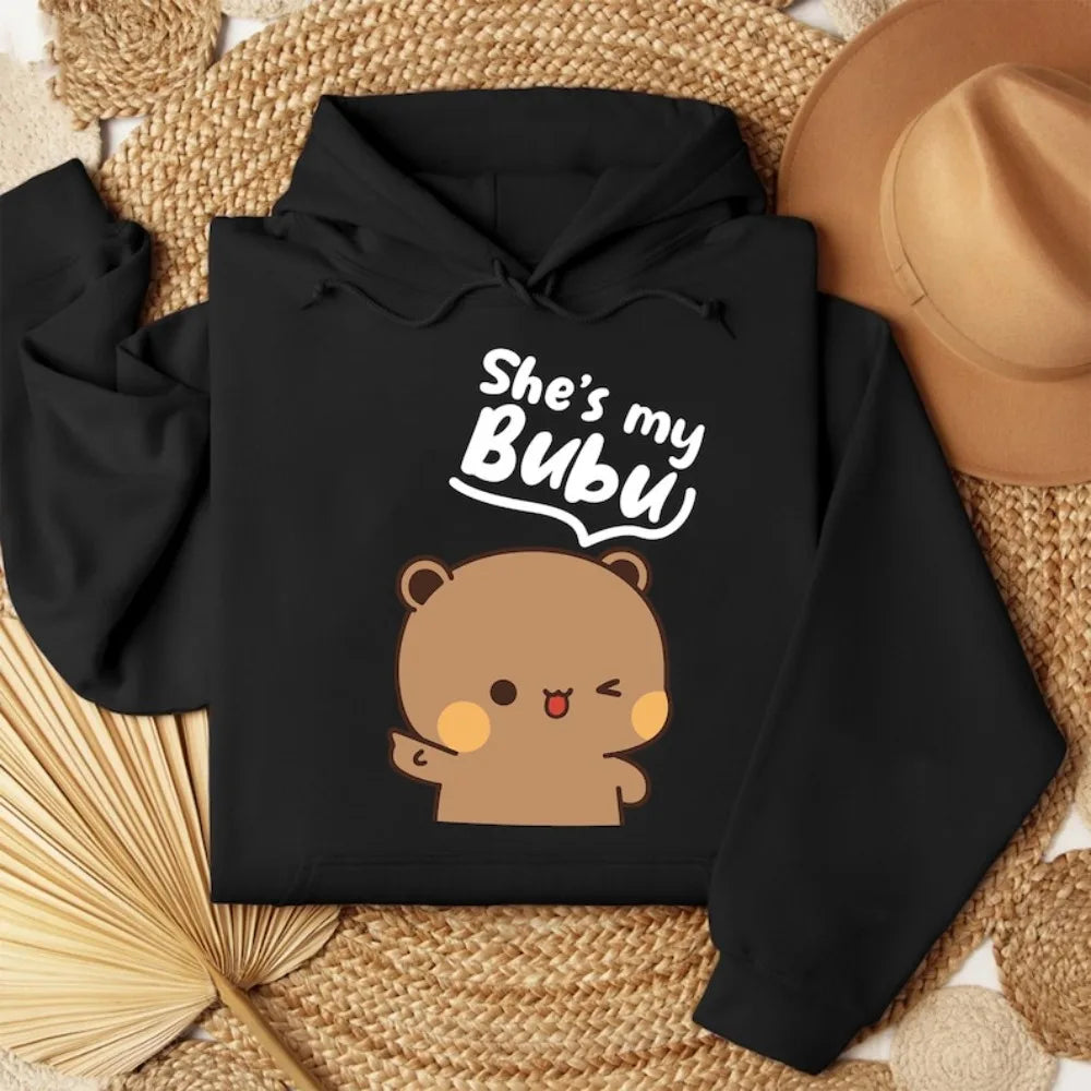 Black hoodie with bear graphic and text 'She's my Bubu' on a woven surface.