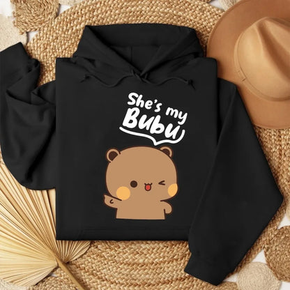 Black hoodie with bear graphic and text 'She's my Bubu' on a woven surface.