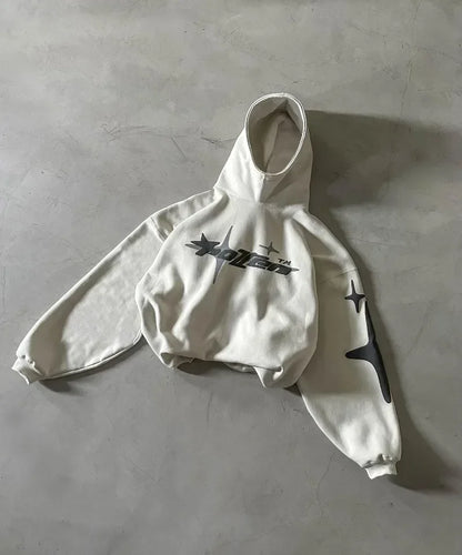 White hoodie with star designs on a gray surface