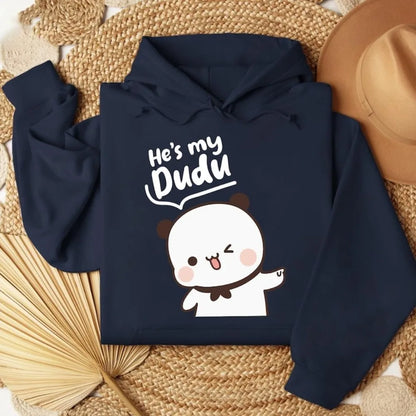Navy blue hoodie with cartoon character and text 'He's my Dudu' on a woven surface.