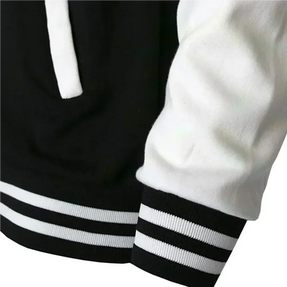 Close-up of a black and white jacket with striped cuffs and hem.