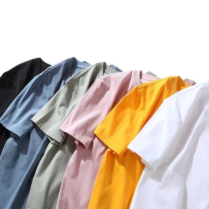 Collection of folded shirts in various colors on a white background